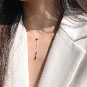 Model wearing an adjustable trendy Y-necklace with suit to showcase the neck line