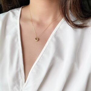 model wearing gold hollow pendant necklace for everyday wear