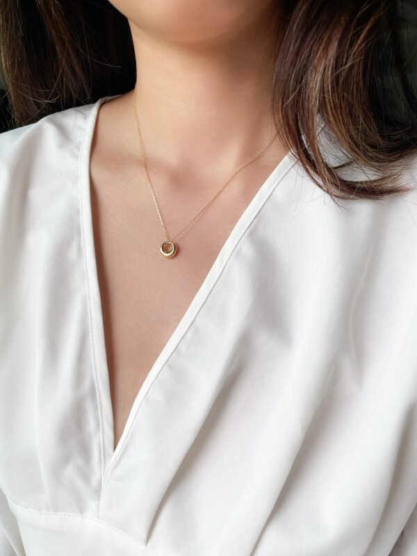 model wearing gold hollow pendant necklace for everyday wear