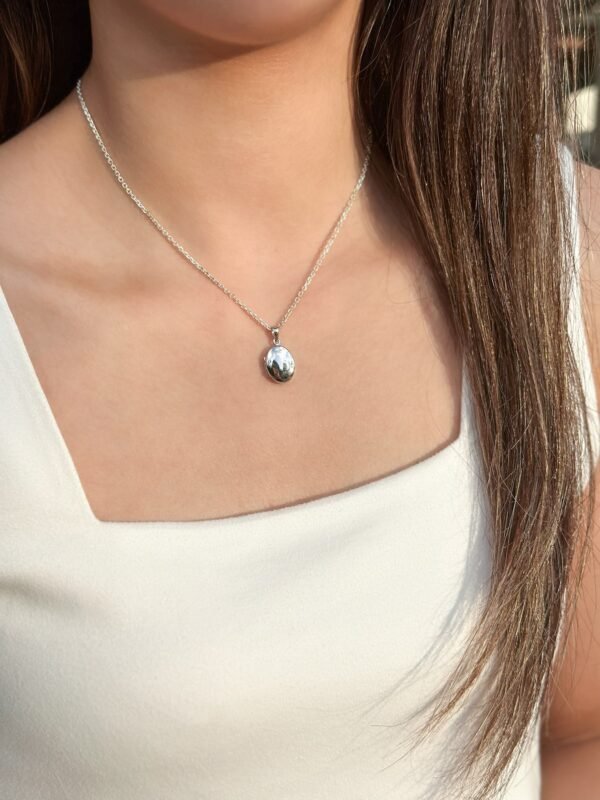 model wearing customised silver oval locket necklace