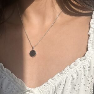 model wearing customised silver circle locket necklace, that the locket can carry photos with engraving at the front of the locket to carry memories